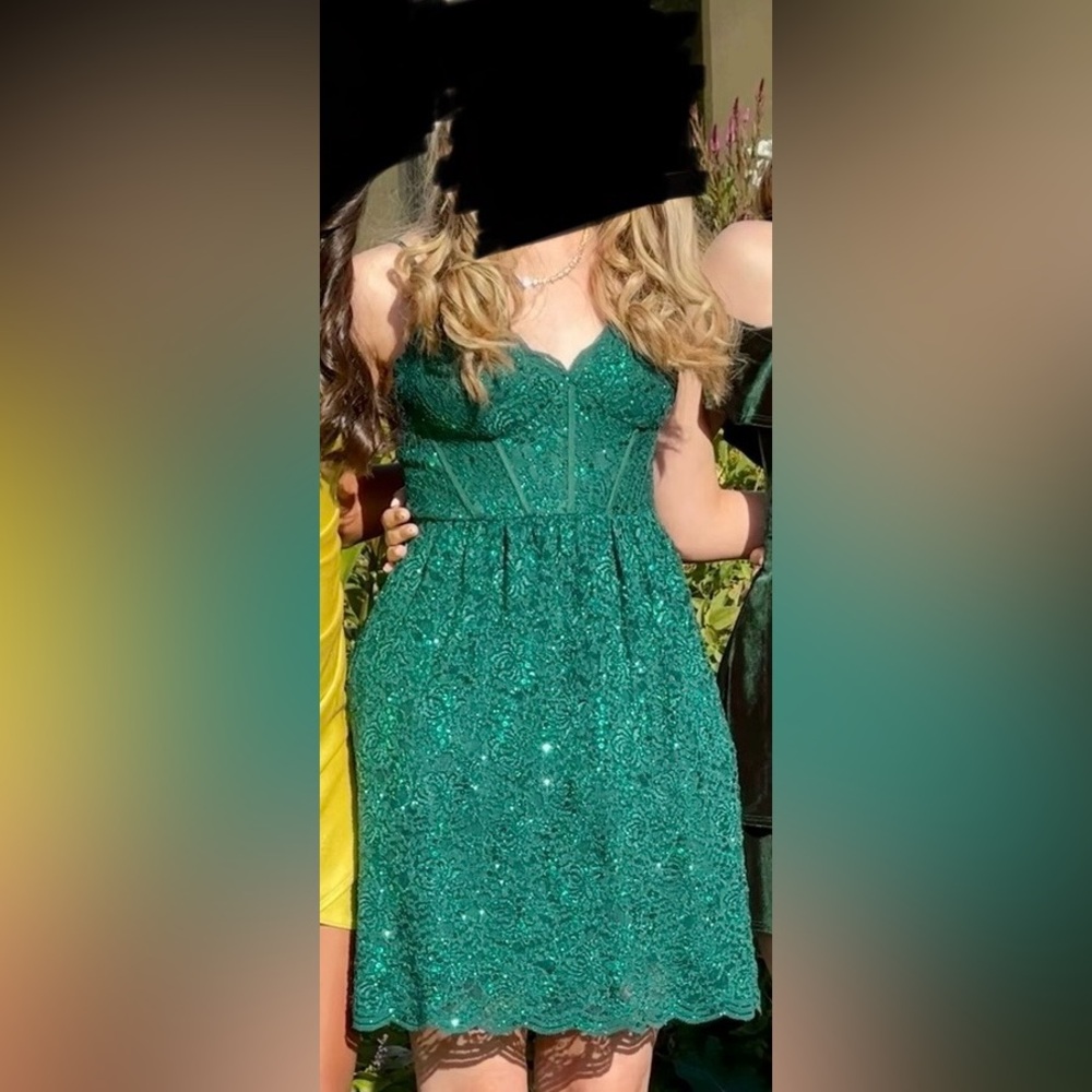 Emerald green homecoming dress with subtle floral pattern. Formal dress.